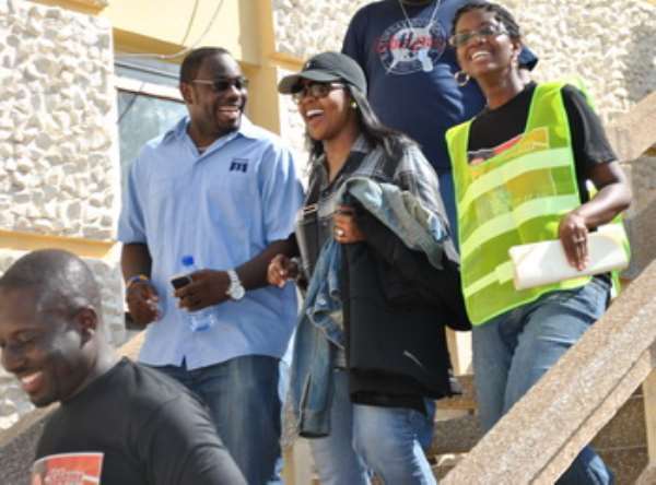 Cene Winans (in cap) descending the stairs at the VIP Lounge of the Kotoka International Airport in the company of officials of Adom FM