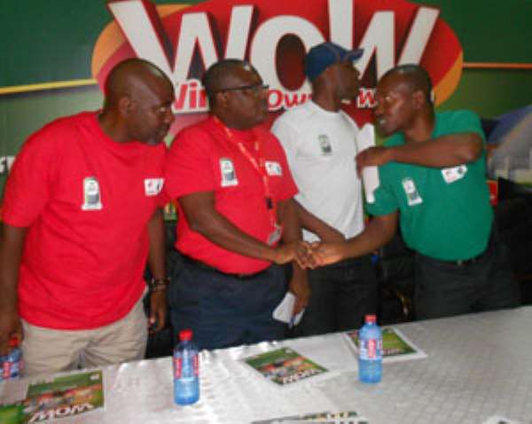 Philip Sowah (second from right) in a hand shake with Kplorlali Shine Gbologa after the launch