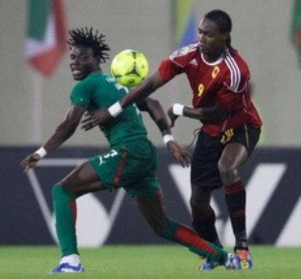 Angola's Manucho, right, edges past Burkina Faso's Florent Rouamba during their African Cup of Nations Group B match at Malabo Stadium in Malabo, Equatorial Guinea, Sunday, Jan. 22, 2012. Photo: Rebecca Blackwell / AP