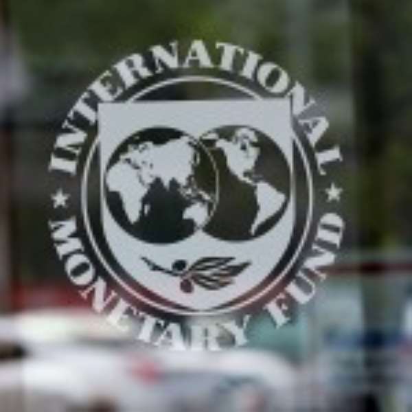 Seth Terkper, Finance Minister exchanges documents with an IMF official after a review
