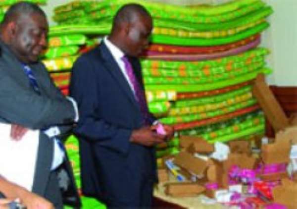 Mr Haruna Iddrissu (right), Communications Minister and Mr Paarock Van Percy, Director General of the National Communication Authority, inspecting some of the seized illegal Sim cards.