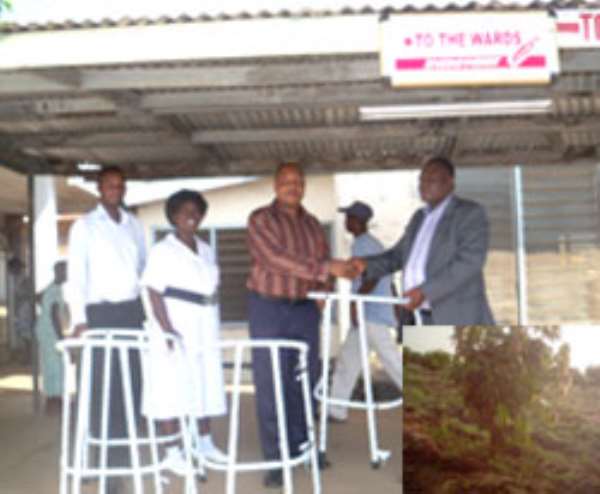 Mrs. Christiana Awuyah Ahiadzro (right) and Mr. Ahiadzro (left) receiving the award from an agriculture officer at the Farmers Day celebration (left), INSET: The 170-acre mango farm cultivated by Mr. Prince Ahiadzro at Dzodze
