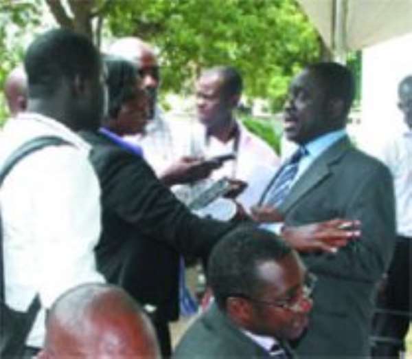 Nana Adjei Ampofo (standing 2nd right), the Chairman of the Lands Commission, speaking to media men at the press conference at the Press Centre in Accra.
