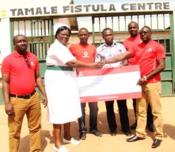 Some Vodafone Employees Presenting The Cheque To The Centre