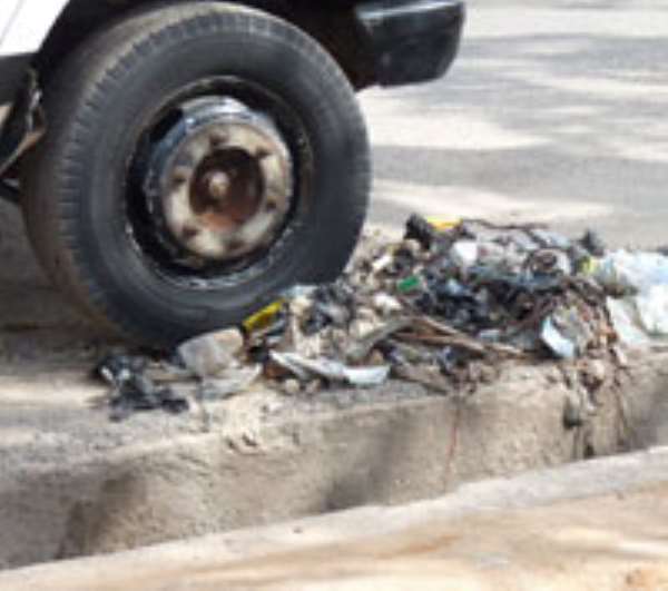 Rubbish cleared from the gutter and left beside the road only to be swept back in with the next rainfall