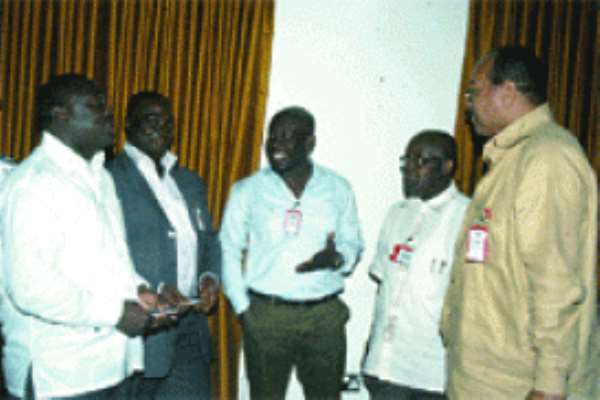 Mr Osei Kwame Agyeman, President of GIA (extreme left) & Nii Teiko Evans-Anfom, immediate past President of GIA (extreme right), interacting with some participants at the workshop.
