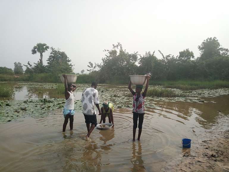 Some residents of Atieve fetching the water for domestic use