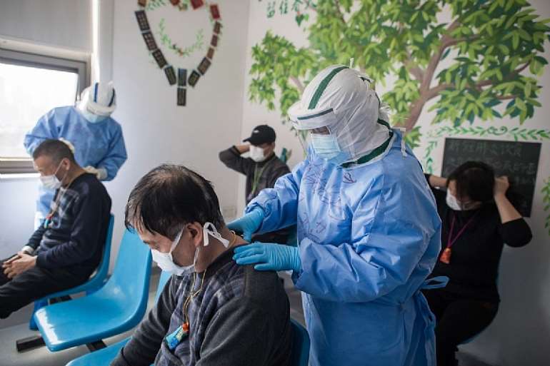 Medical workers massage patients' acupuncture points at the Wuhan pulmonary hospital in Wuhan. Photo: Xinhua