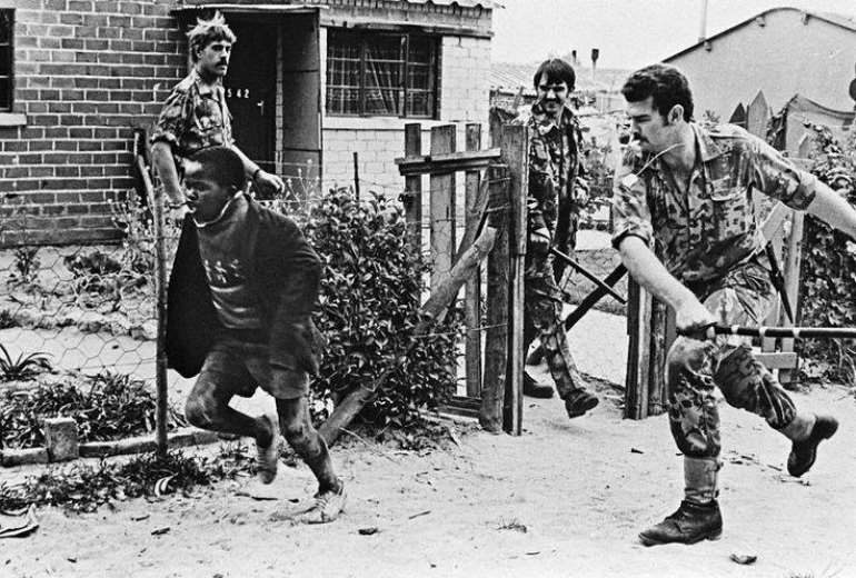Picture of shame: An innocent black boy escapes the wrath of Apartheid White killer.