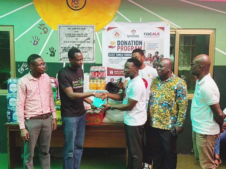 <em>Leader of Bright Future Movement, Yaw Worlanyo, hands over items to SCEF</em>
