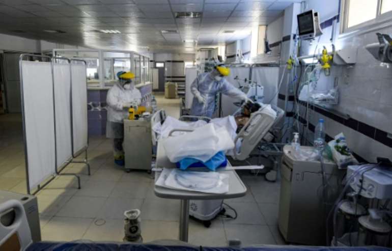Nurses wearing personal protective equipment care for an intubated Covid-19 patient in an intensive care unit at a hospital in the town of Gabes in southwestern Tunisia.  By FETHI BELAID (AFP/File)