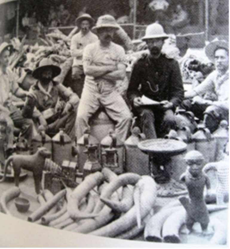 Members of the infamous Punitive Expedition of 1897 proudly posing with looted Benin artefacts.