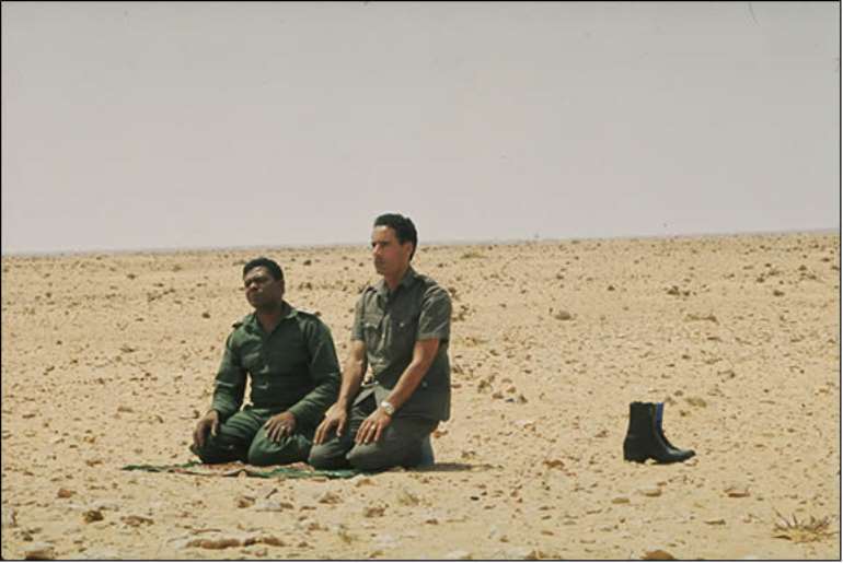 Muammar Qaddafi and Yunis Jaber praying in the desert near Sirte in 1973