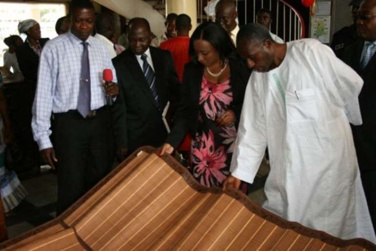 Mr Colins Dauda, (right) Minister of Lands and Natural Resources looking at exhibited items display. With him is Mrs Zita Okakoi, (left) Minister of Information and some another Chief executives from the Ministry.