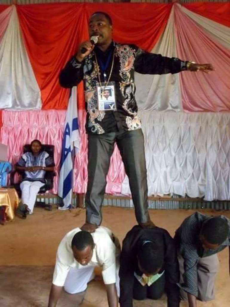 tanzanian pastor stands on members