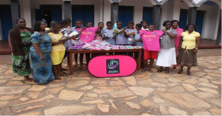 Representatives from the Girl Child Education Unit of the Ghana Education Service and participants admiring samples of the educational materials and T-shirts donated by Zain