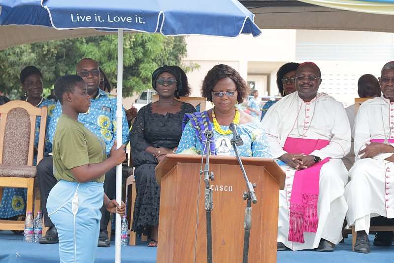 Madam Abla Avevor, Headmistress of St. Catherine Senior High School in the Keta-Akatsi Diocese addressing the audience. Seated Behind are Bishop Anthony Adanuty Founder of School and Bishop Gabriel Kumordji of Keta-Akatsi October 19, 2019. Photo by Damian Avevor
