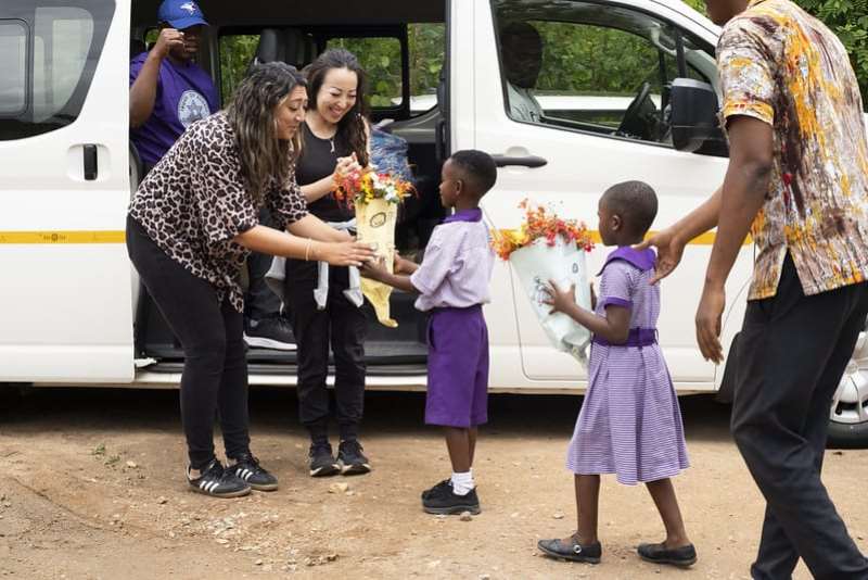 Gihnee Rancourt,  Founder of Our Future Prize and Haneen Khalaf, Director of Global Business Development at Learning Upgrade being welcomed by some pupils at the Impact Hub Academy, of the beneficiaries of the free Starlink Internet Installation programme in the Volta Region.Photo Credit: Mac House - USA