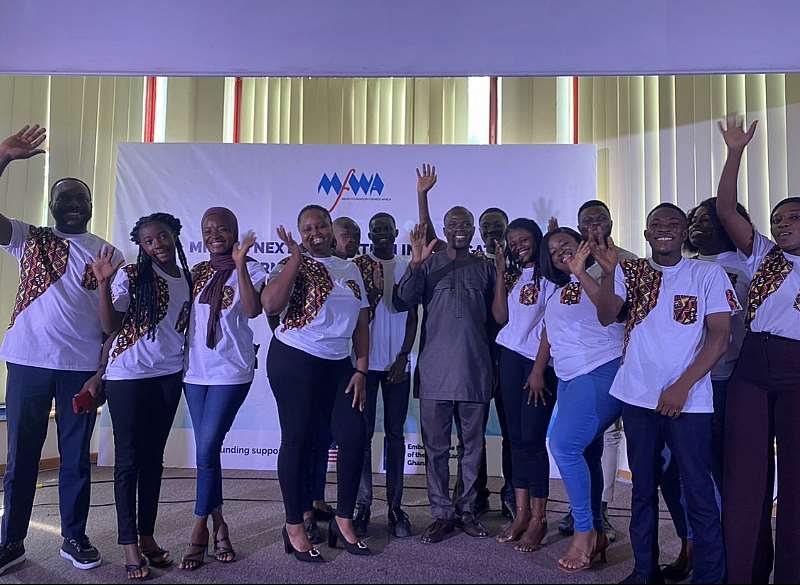 The 13 fellows in a group photograph with some organizers