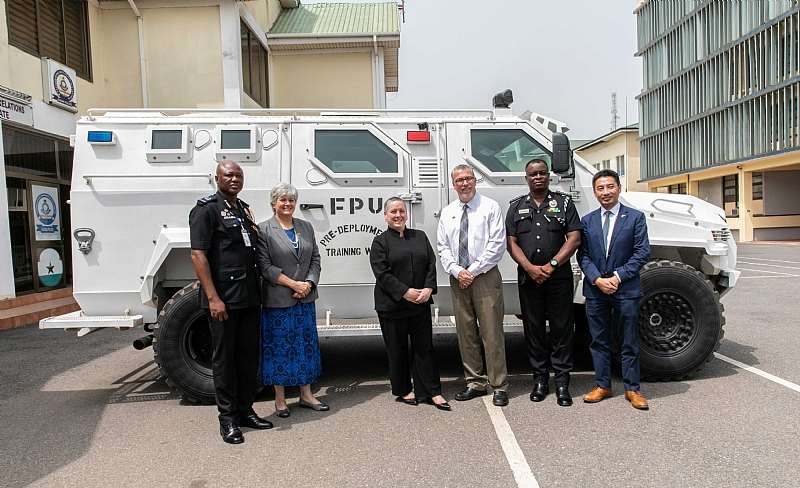U.S. Department of State Assistant Secretary for the Bureau of International Narcotics and Law (INL) Enforcement Affairs Kirsten Madison (middle in black suit) and the U.S. Ambassador to Ghana Stephanie S. Sullivan pictured with (Left to Right) GPS International Relations Directorate Director ACP Baba Saanid Adamu, Police Peacekeeping Deployment and Logistics Subject Matter Expert in Accra Clarence Duncan, Deputy Superintendent (Administration & Pre-Deployment Training FPU) WhoKnows Kwaku Attipoe, and INL Director Jeff Kee.  The group is standing in front of a U.S. donated Armored Personnel Carrier truck that was handed over on April 18, 2018 as a part of the U.S. Governments efforts to enhance capacity of the Ghanaian Police to deploy operational and effective peacekeepers.