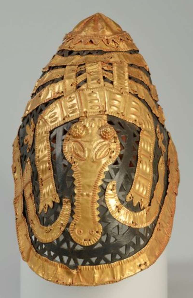 Krobonkye cap with gold strips, usually worn by state sword bearers and important officials. Looted in 1874 invasion of Kumasi by British Army, now in Royal Trust Collection. Among the loot of thousand objects from Asantehene Kofi Karkari.