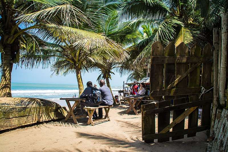 Tourists Relaxing At The Kokrobite Beach