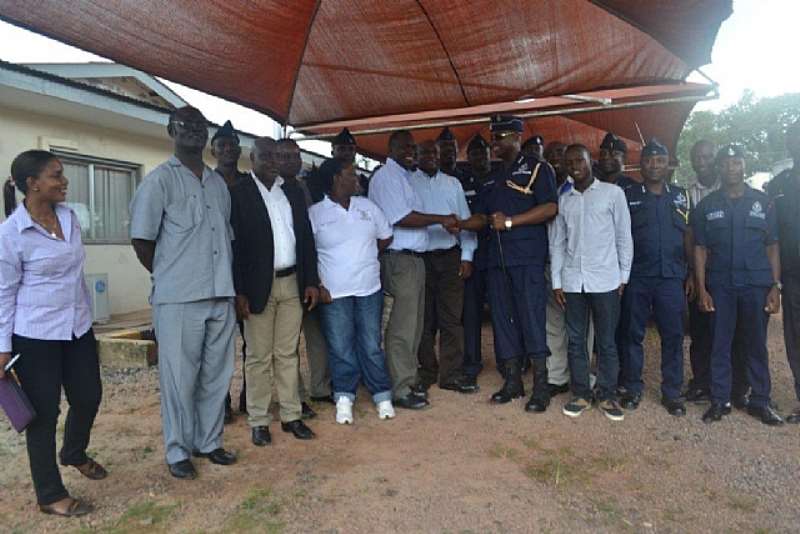 ACTING MD OF ANGLOGOLD ASHANTI IDUAPRIEM MINE, SAMUEL NOI IN A HANDSHAKE WITH DCOP KOFI BOAKYE LOOKING ON IS A SNR. COMMUNICATIONS OFFICER OF THE MINE SEKYIWA DARKO