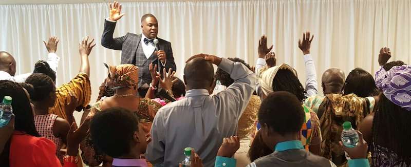 Bishop Adonteng With Microphone In Hand At 1st Service Of Georgia Duluth Usa Branch Of Dwm On May 8, 2016. Photo Courtesy Theafricandream.net