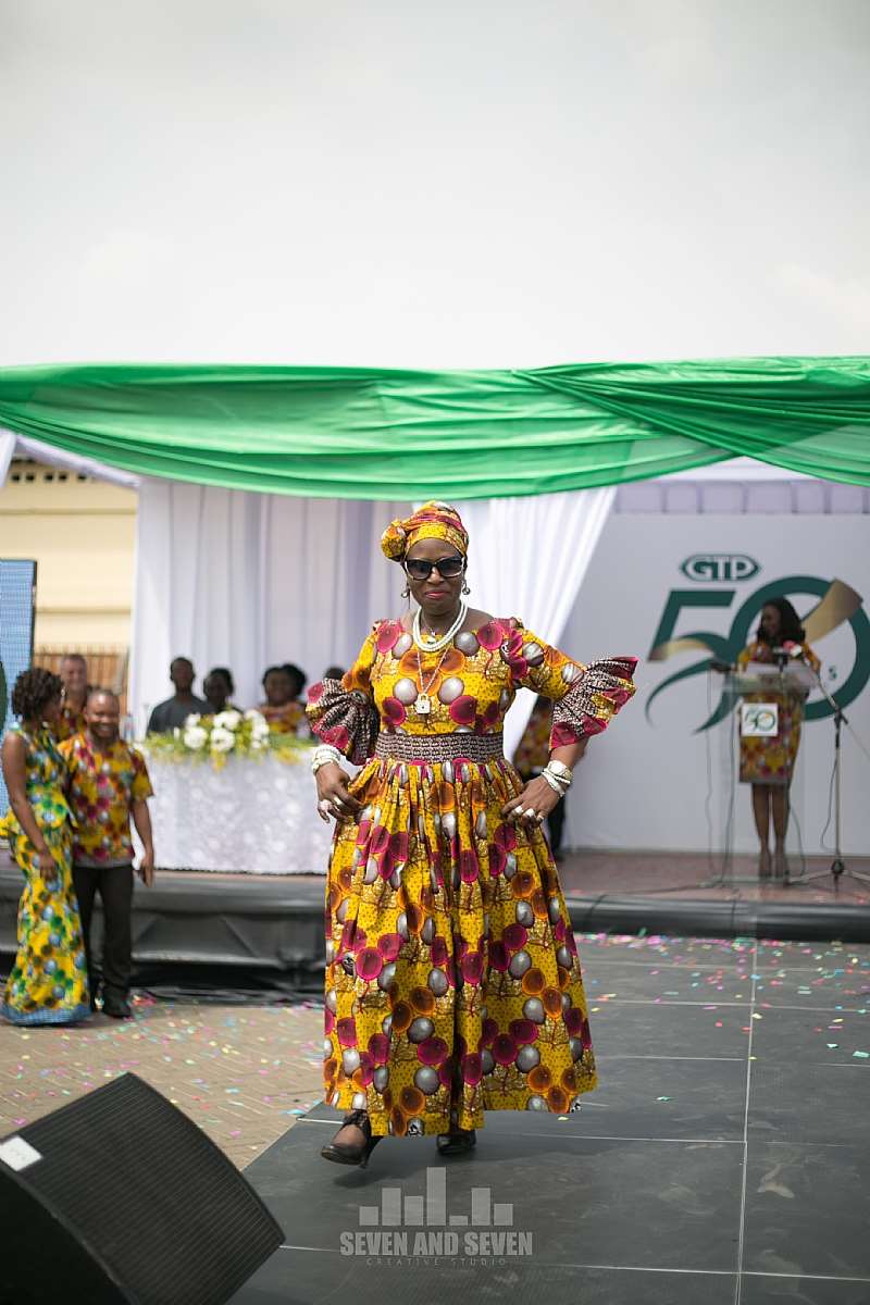 A STAFF FLAUNTING HER BEAUTIFULLY DESIGNED 50TH ANNIVERSARY CLOTH ON THE RUNWAY