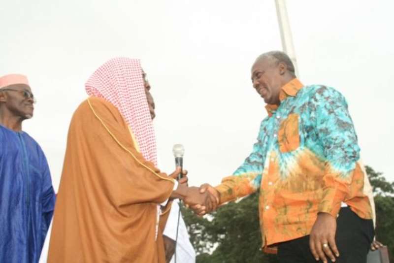 SHEIKH UMAR IBRAHIM IMAM IN A HANDSHAKE WITH THE VICE PRESIDENT AFTER THE EID UL FITR PRAYERS.