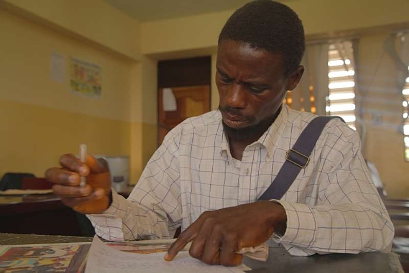 One Of The Church Members Writes His Statement At The Police Station