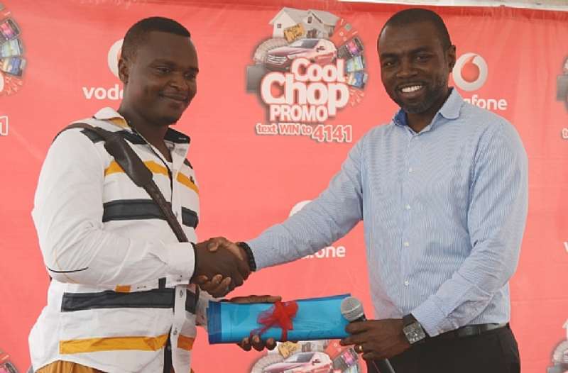 MR SARKODIE OKOH BEING GIVEN THE LAND DOCUMENTS FOR THE LAND HE WON FROM COOL CHOP
