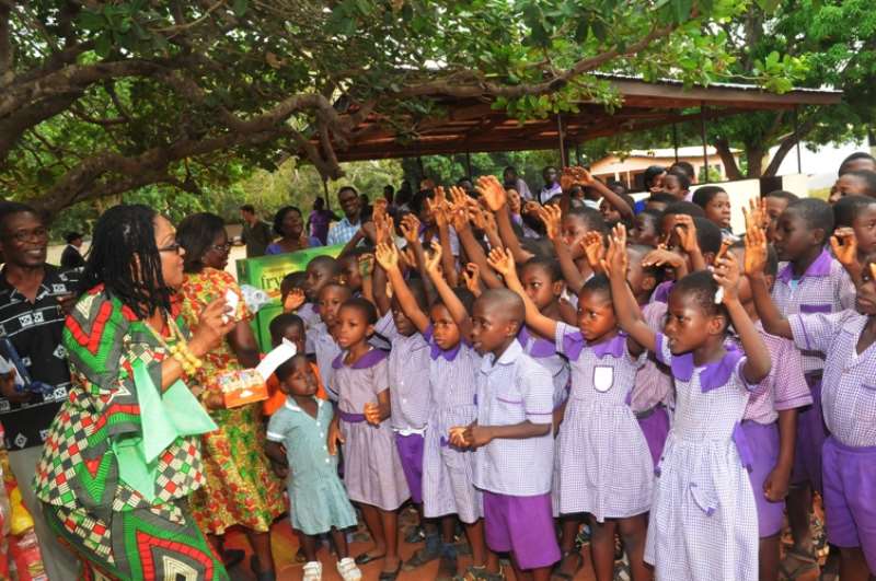 NANA LORDINA SHARING CHOCOLATE TO CHILDREN AT CHRIST FAITH FOSTER HOME, FRAFRAHA, ACCRA