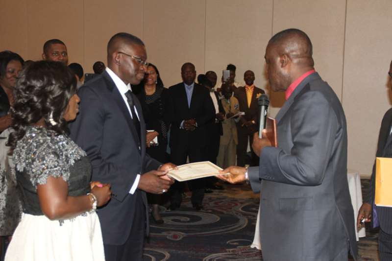 REV. AND MRS. GYAWU RECEIVING THE CERTIFICATE OF ORDINATION