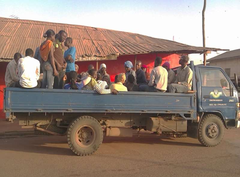 SOME PERSONNEL AND VOLUNTEERS DRESSED IN THEIR OWN CLOTHING WAITING FOR THEIR COLLEAGUES TO JOIN THEM FOR A TAKEOFF TO THE FARM