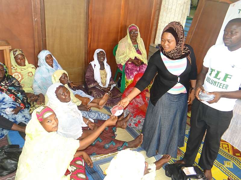 TLF VOLUNTEERS GIVING OUT AUDIO CDS TO PARTICIPANTS AT THE KARDOR MOSQUE