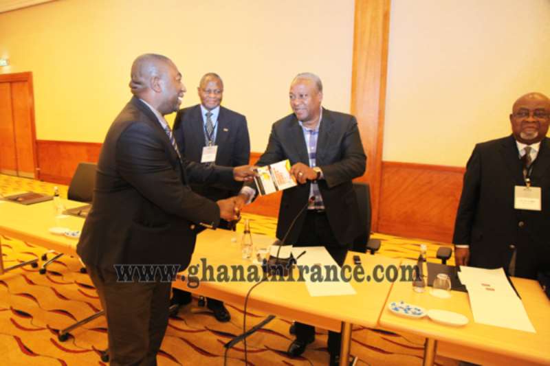President Mahama receiving the Book from the Author Osei Mensah Michael while Defence Minister Gen. Smith and Ambassador Ibrahim Abass look on.