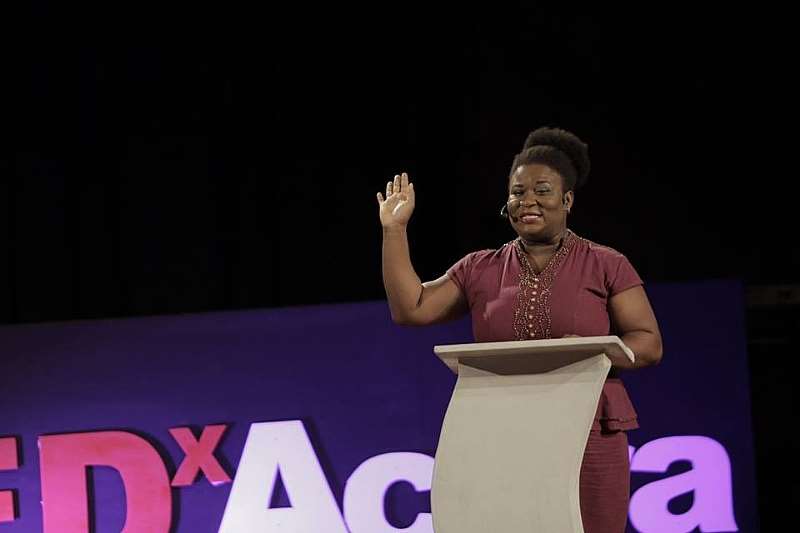 YAWA SPEAKS WITH HAND RAISED AT TEDXACCRA
