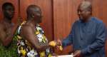 Asantehene Otumfuo Osei Tutu IIleft, presenting the Bawku Mediation Report to President John Dramani Mahama