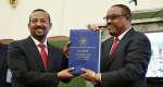 Outgoing prime minister Hailemariam Desalegn (right) hands a copy of the Ethiopian constitution to his successor Abiy Ahmed in 2018. - Source: Wikimedia Commons