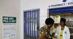 A woman receives medication at Phedisong clinics pharmacy on April 8, 2013 during the launch of the new single dose anti-AIDs drug in Ga-Rankuwa.  By Stephane de Sakutin (AFP/File)