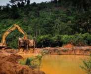 An excavator operator busily destroying water bodies