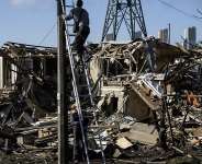 Electricians restore the power grid in front of a destroyed private house where a 14-year-old was killed in an air attack in Vyshgorod on September 30, 2026. - Vladyslav Musiienko, AFP