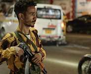 A member of the security forces of the internationally-recognised Yemeni government mans a checkpoint on a street in Taiz - AFP