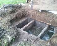 Damaged septic tank under repairs.