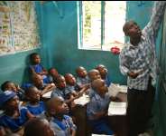 This Picture Shows A Teacher In Class With Schoolchildren. This Is The Best Time To Start Teaching Children About Corruption And Its Vices