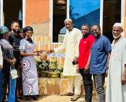 Abbi Ima, donating to the Kingtampo Muslim community.