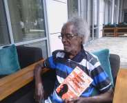 Author Emmanuel John Hevi with a copy of his first book