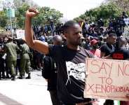 A protestor gestures and holds a placard during a demonstration in front of the South African Embassy in Lusaka, Zambia on September 4, 2019 (Source: CNN)