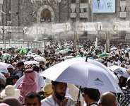 Muslim worshippers walk along the Grand Mosque complex under the water-mist fans installed in the holy city of Mecca on May 24, 2026, ahead of the annual Hajj pilgrimage. -  Zain Jaafar, AFP